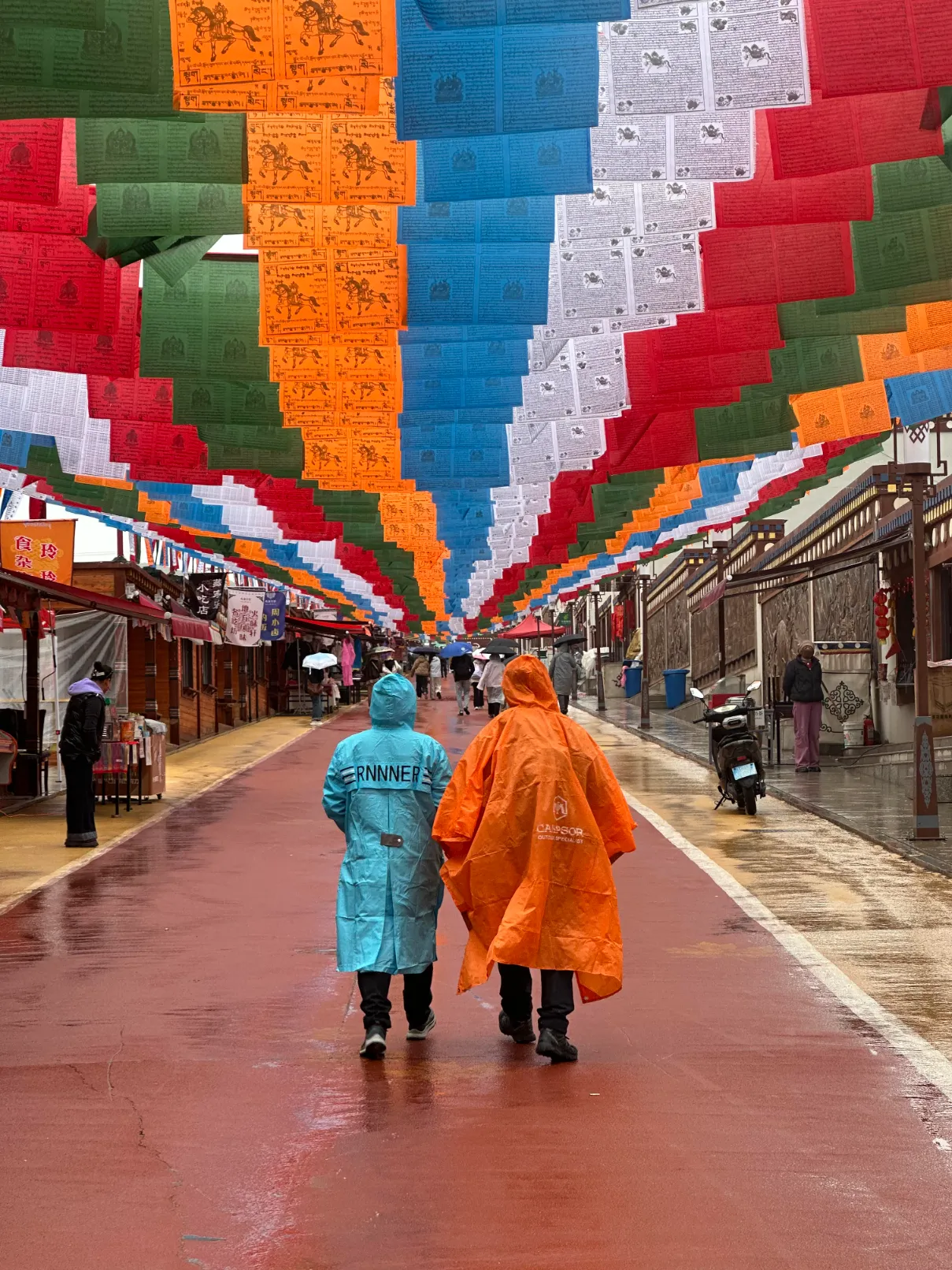 People below a colorful decoration