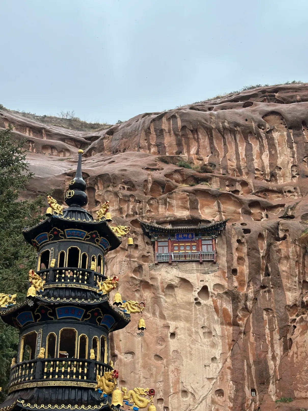 Floating temple behind a pagoda in the cliff wall