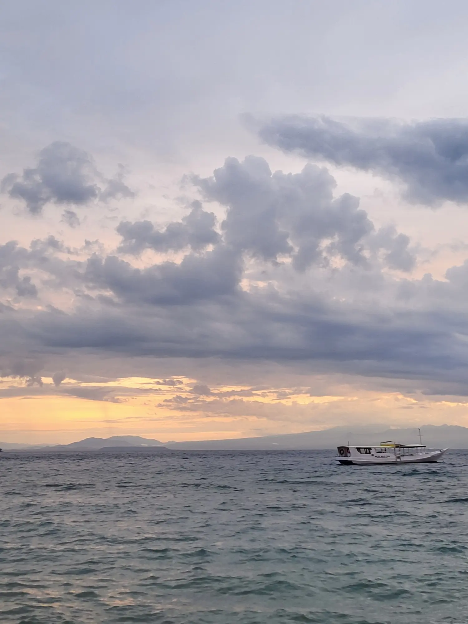 Moyo island sunset with boat